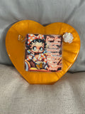 Small orange-gold resin heart. Betty Boop with flowers